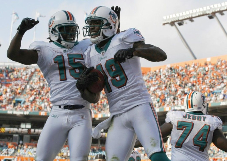 Miami Dolphins Davone Bess celebrates with teammate Brandon Marshall after Marshall scored a touchdown against the Buffalo Bills during fourth quarter NFL football game in Miami