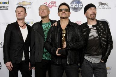 Members of the band U2 pose in the photo room after winning the Top Touring award during the 2011 Billboard Music Awards show in Las Vegas
