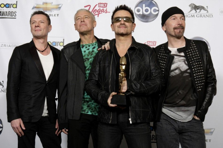 Members of the band U2 pose in the photo room after winning the Top Touring award during the 2011 Billboard Music Awards show in Las Vegas