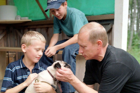 RUSSIAN PRESIDENT PUTIN PATS THE DOG ON THE HEAD IN VERKHNIE MONDROGI.