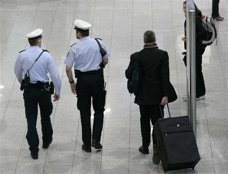 Police officers observe the scene inside the main terminal of Frankfurts airport