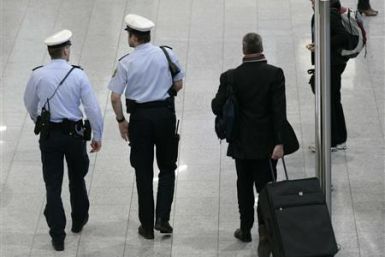 Police officers observe the scene inside the main terminal of Frankfurt`s airport