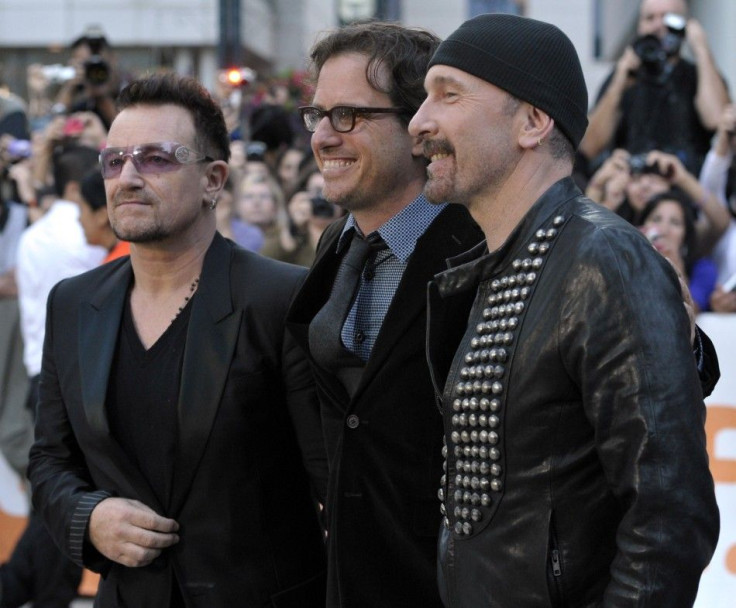 U2&#039;s Bono and The Edge pose with director Davis Guggenheim at gala presentation for documentary film at 36th Toronto International Film Festival