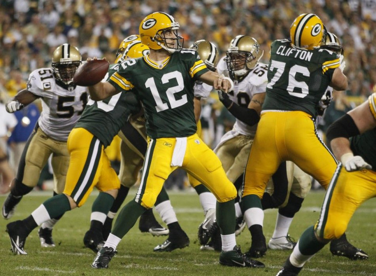 Green Bay Packers quarterback Aaron Rodgers throws a pass against the New Orleans Saints during the second half of their NFL football game in Green Bay