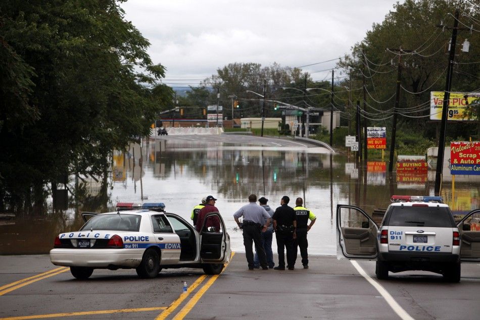 Law enforcement officers look at flooding from the Susquehanna River in Kingston, Pennsylvania