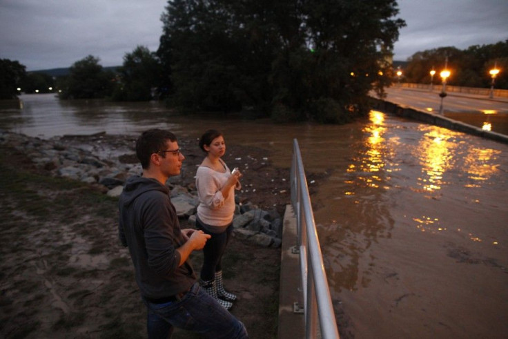 Joe Senchak and Jenis Walsh stand at a flood wall on the Susquehanna River in Kingston