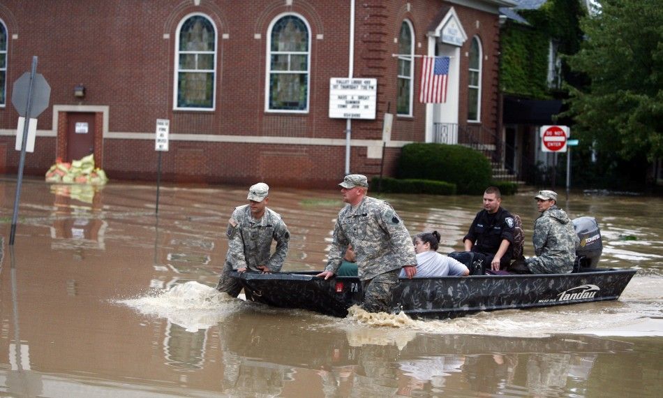 U.S. National Guard troops rescue David Rowlands and Linda Rowlands from floodwaters from the Susquehanna River in West Pittston