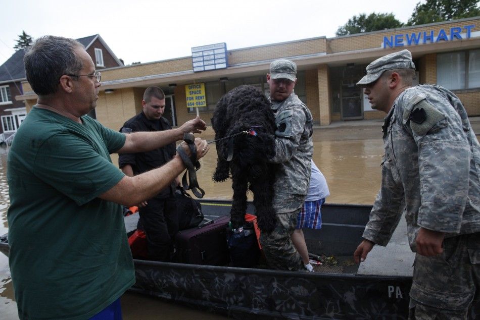 U.S. National Guard troops rescue David Rowlands and his dog Cupcake from floodwaters from the Susquehanna River in West Pittston