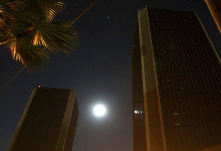 The moon shines behind buildings during a power outage in downtown Tijuana