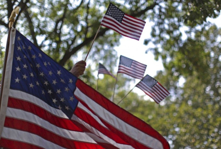 Tea Party supporters wave U.S. flags during a rally in Cedar Rapids