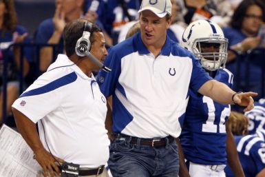 Colts Peyton Manning and Clyde Christensen talk during a preseason NFL football game in Indianapolis