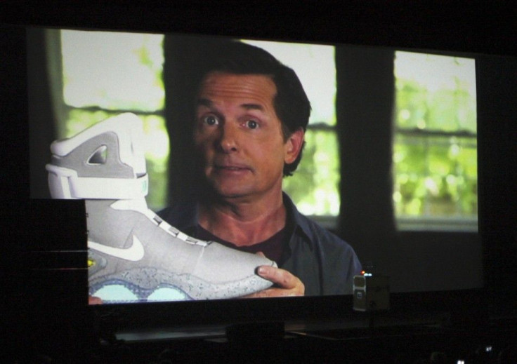 Actor Michael J. Fox is seen on a screen during a video message holding a 2011 NIKE MAG shoe
