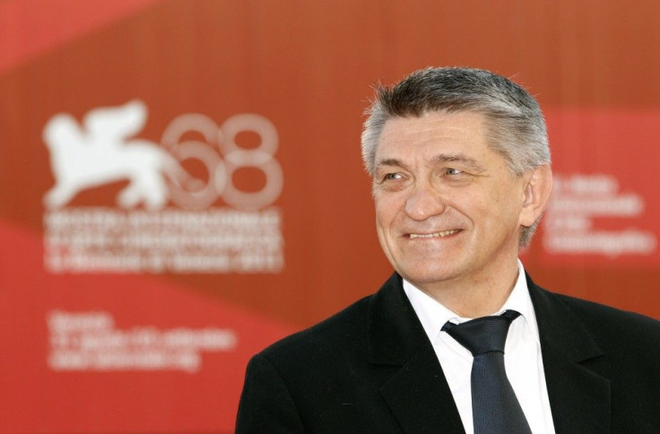 Sokurov, director of &quot;Faust&quot;, poses for photographers as he arrives to attend the closing ceremony of the 68th Venice Film Festival