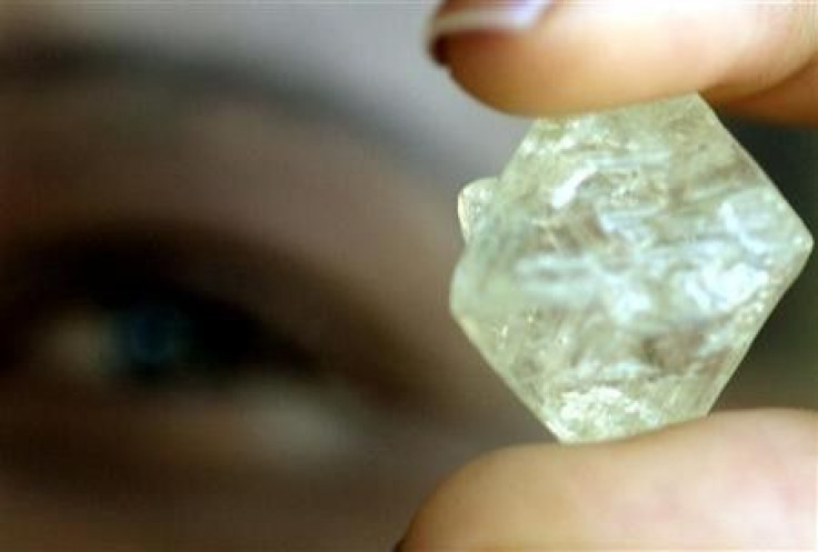 A worker at the Botswana Diamond Valuing Company displays a rough diamond 