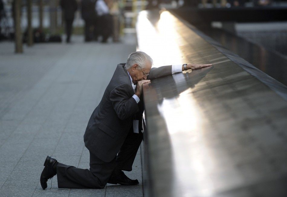 Robert Peraza, who lost his son Robert David Peraza, pauses at his son039s name at the North Pool of the 911 Memorial during tenth anniversary ceremonies at the site of the World Trade Center in New York