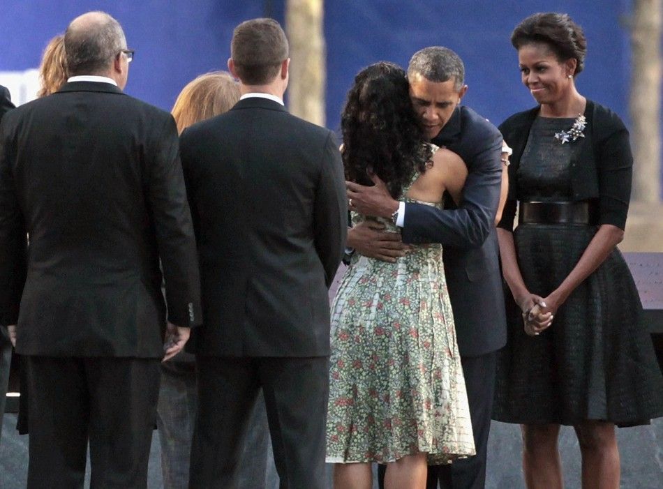 U.S. President Barack Obama embraces victims039 family members as first lady Michelle Obama stands by at the 911 Memorial during the tenth anniversary ceremonies at the World Trade Center site in New York