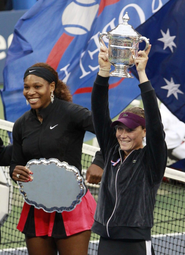 Serena Williams of the U.S. (L) and Samantha Stosur of Australia smile as they hold their trophies after Stosur defeated Williams to win the final of the U.S. Open tennis tournament in New York.