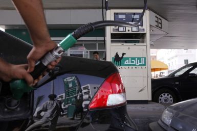 A man fills up the tank of a car at a petrol station in Tripoli
