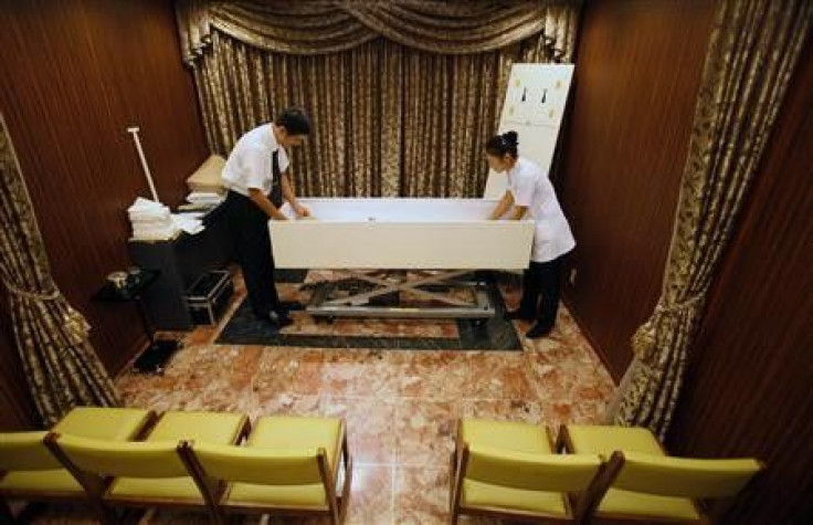 Morticians prepare a body at the Lastel corpse hotel in Yokohama, south of Tokyo, September 10, 2011. Death is a rare booming market in stagnant Japan and the Lastel corpse hotel, where bereaved families can check in their dead while they wait their turn 