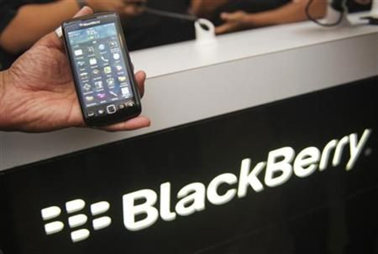 A person poses the new Blackberry Torch 9860 at a release party to promote the BlackBerry OS 7 devices in Toronto