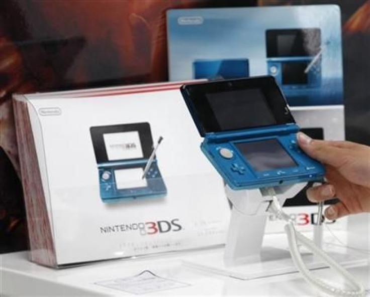 A man plays with the Nintendo 3DS portable game at an electronics shop in Tokyo