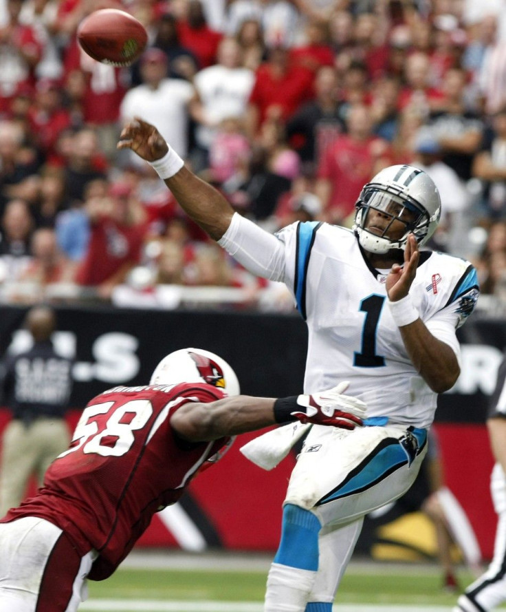 Panthers&#039; Newton throws down field as he is tackled by Panthers&#039; Davis in their NFL football game in Glendale