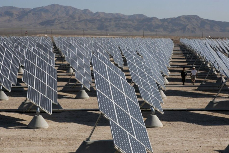 Col. Belote and Vander Leest walk through array of solar photovoltaic panels at Nellis Air Force Base in Las Vegas