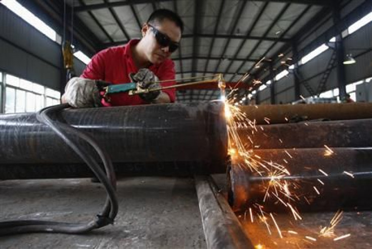A worker welds steel pipes at a factory in Suining