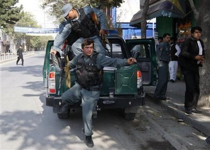 Afghan policemen arrive at the site of a rocket-propelled attack in Kabul
