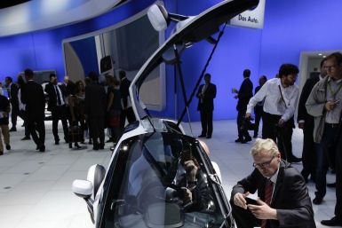 Visitors look at the German car manufacturer Volkswagen (VW) concept car &quot;Nils&quot; at the VW exhibition booth during the International Motor Show (IAA) in Frankfurt