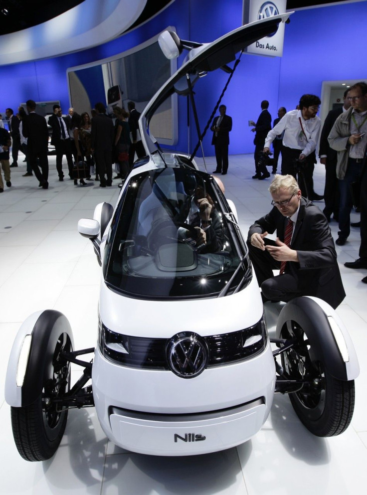 Visitors look at the German car manufacturer Volkswagen (VW) concept car &quot;Nils&quot; at the VW exhibition booth during the International Motor Show (IAA) in Frankfurt