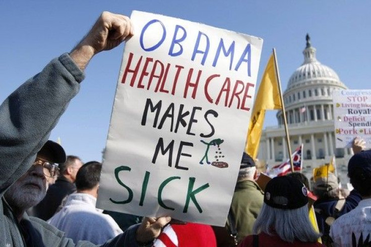 A demonstrator holds up a sign during a &quot;House Call&quot; rally against proposed healthcare reform legislation at the Capitol in Washington November 5, 2009.