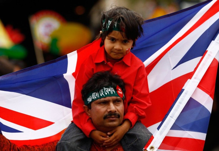 A man and boy take part in the Bengali New Year parade towards the city&#039;s East End, during the Baishaki Mela festival in London