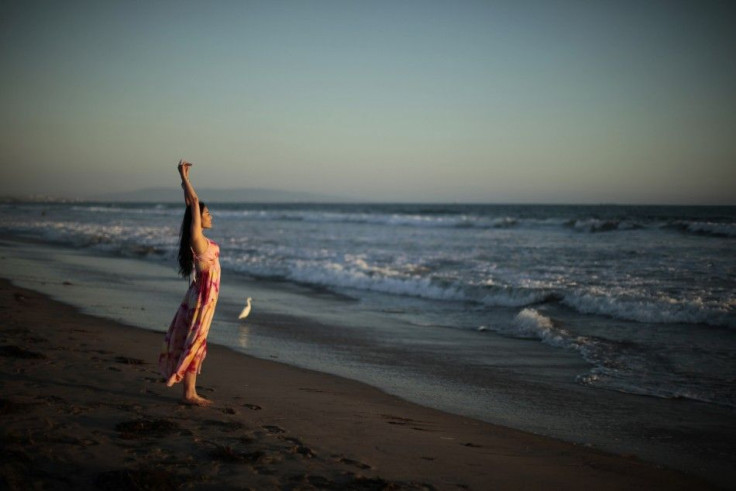 Tiffany Zeng of China stretches on the beach in Santa Monica