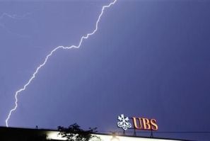 Lightning strikes over the headquarters of Swiss bank UBS during a thunderstorm over the Paradeplatz square in Zurich