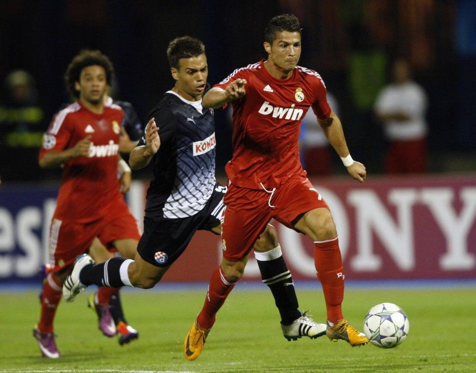 Cristiano Ronaldo R of Real Madrid challenges Adrian Calello of Dinamo Zagreb during their Champions League Group D soccer match at the Maksimir stadium in Zagreb September 14, 2011