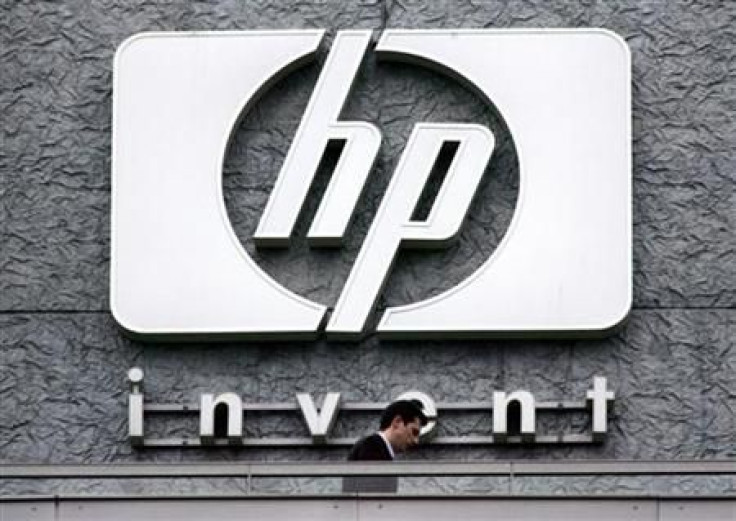 File photograph of a man walking past the Hewlett Packard logo at its French headquarters in Issy le Moulineaux