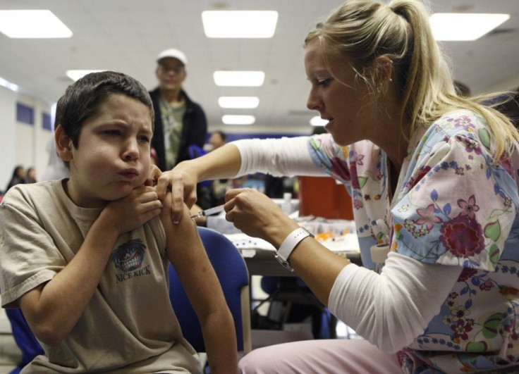 Adams, 10, reacts as nurse Fawna Dougoud administers his shot of the H1N1 vaccine in Haltom City