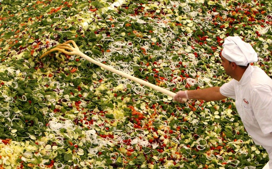 A cook prepares the worlds biggest green salad