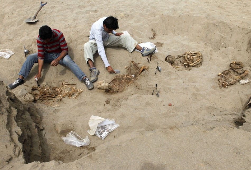 Archaeological students clean some of the unearthed remains of 42 children and 74 camelids, sacrificed approximately 800 years ago and found in the fishing town of Huanchaquito, Trujillo