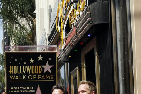 Actor Neil Patrick Harris (R) and his partner David Burtka pose together during ceremonies honoring Harris with a star on the Hollywood Walk of Fame in Hollywood September 15, 2011. The star was placed near the Frolic Room cocktail lounge sign background.