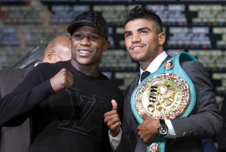 Undefeated boxer Floyd Mayweather Jr. and WBC welterweight champion Victor Orti pose during a news conference at the MGM Grand hotel-casino in Las Vegas