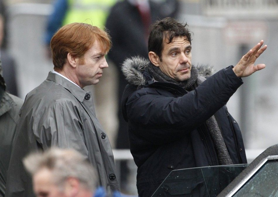Actor Hugo Weaving L listens to the director Tom Tykwer during filming of quotCloud Atlasquot in Glasgow, Scotland