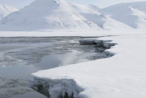 Ice breaks away from a frozen coastline near the Norwegian Arctic town of Longyearbyen