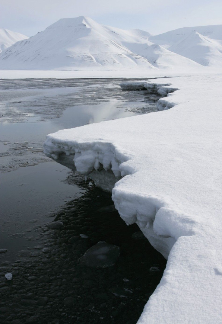 Ice breaks away from a frozen coastline near the Norwegian Arctic town of Longyearbyen