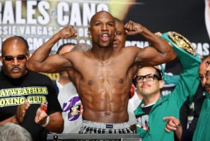 Undefeated welterweight boxer Floyd Mayweather Jr. of the U.S. flexes his muscles on the scale during an official weigh-in at the MGM Grand Garden Arena in Las Vegas, Nevada