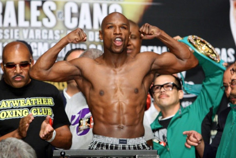 Undefeated welterweight boxer Floyd Mayweather Jr. of the U.S. flexes his muscles on the scale during an official weigh-in at the MGM Grand Garden Arena in Las Vegas, Nevada