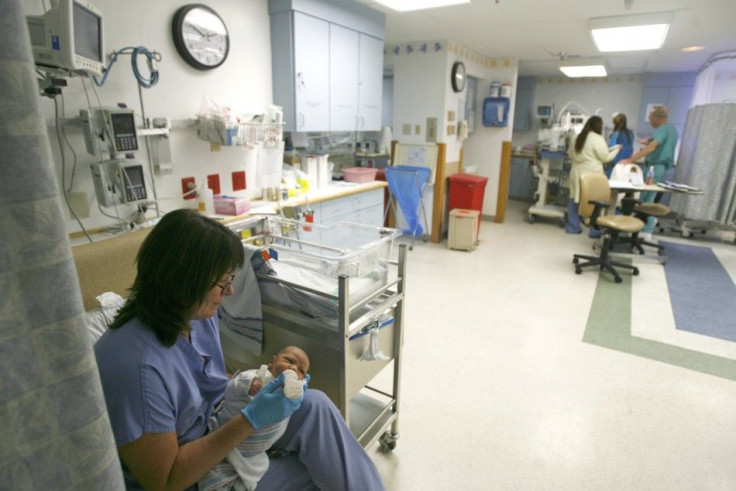 A nurse feeds a baby in the neonatal intensive care unit at the Virtua Health facility in Vorhees, New Jersey