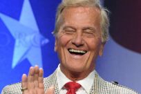 Entertainer Pat Boone laughs as he accepts a lifetime achievement award at the Conservative Political Action conference in Washington