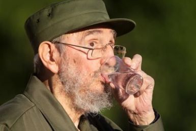 Former Cuban leader Fidel Castro drinks water during a meeting with students at Havana&#039;s University